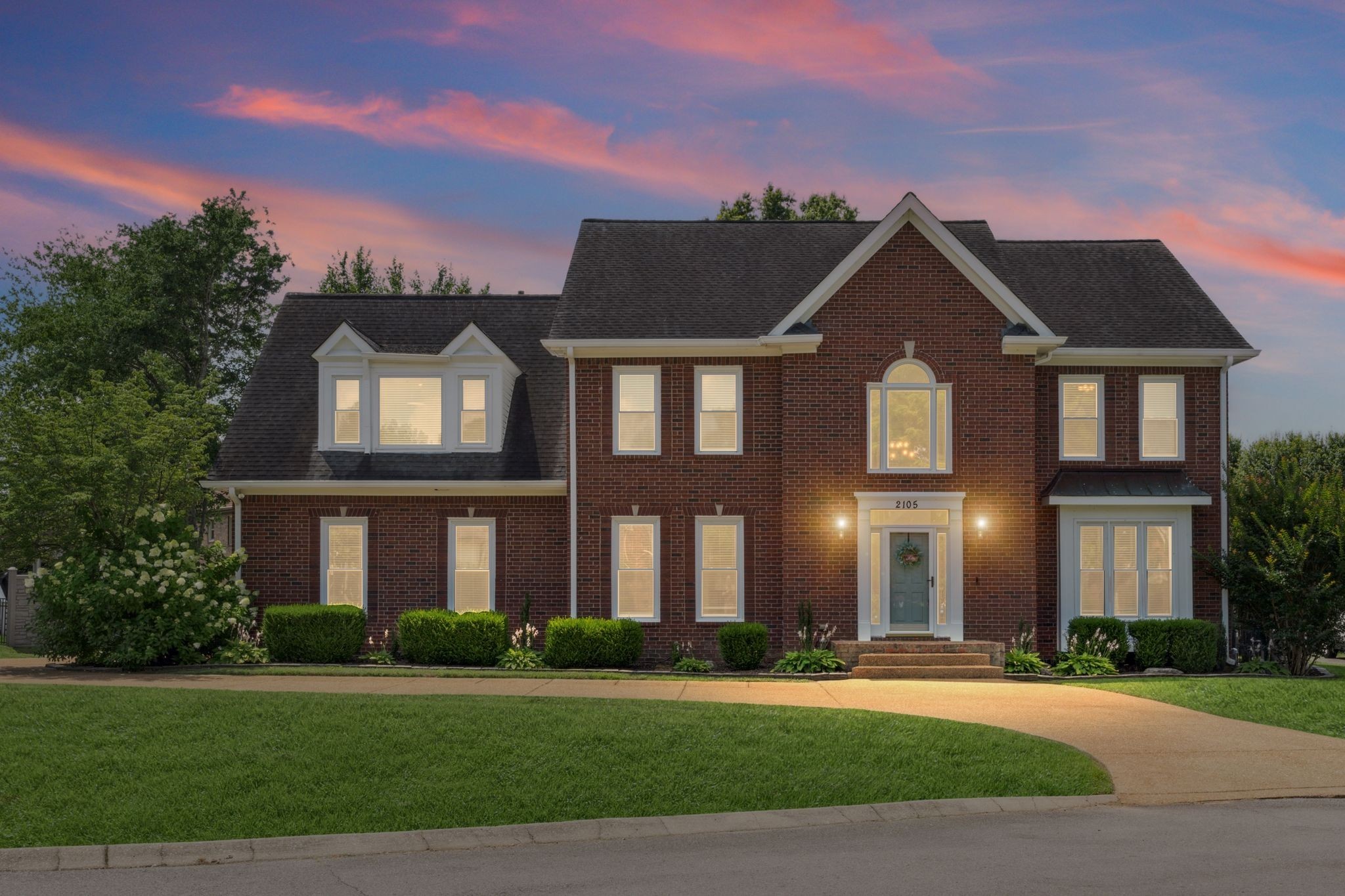 a front view of a house with a yard