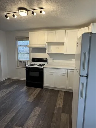 a kitchen with stainless steel appliances a stove a refrigerator and a sink