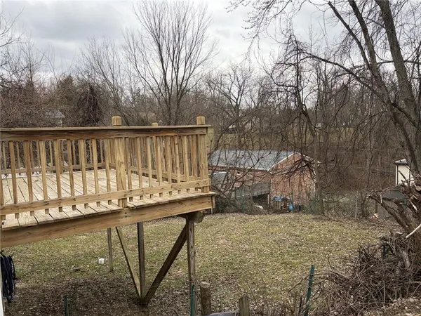 a view of a roof deck with wooden fence and floor