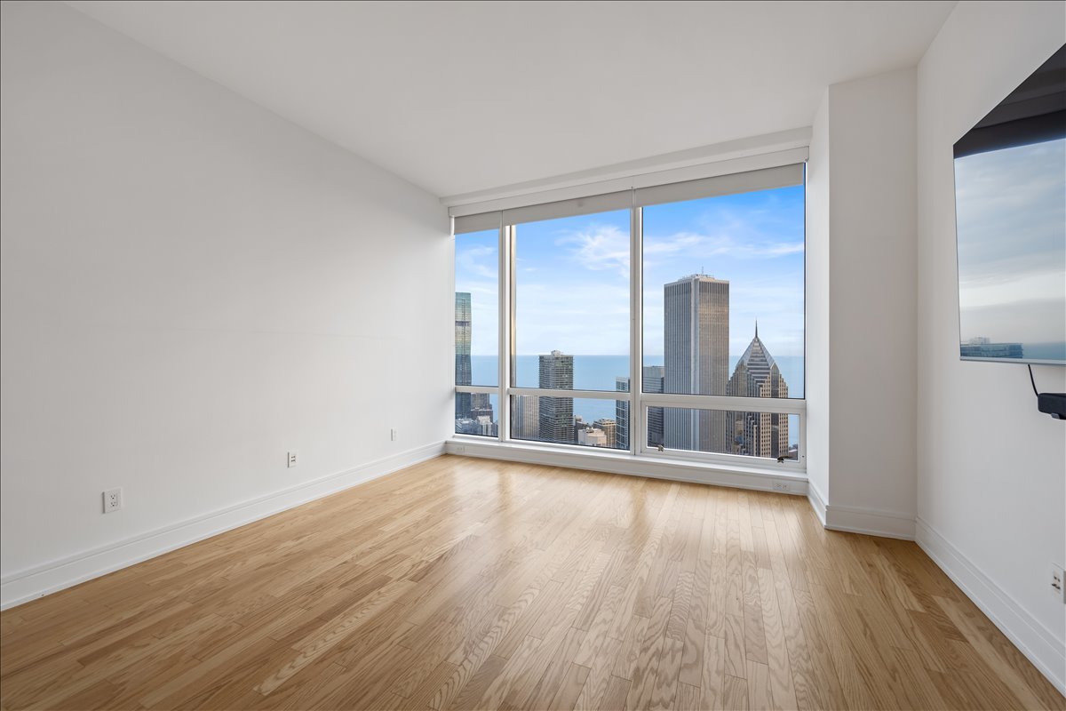 401 North Wabash Avenue, Unit 67F Chicago, IL 60611 - Photo 13 of 44 wooden floor in an empty room with a window