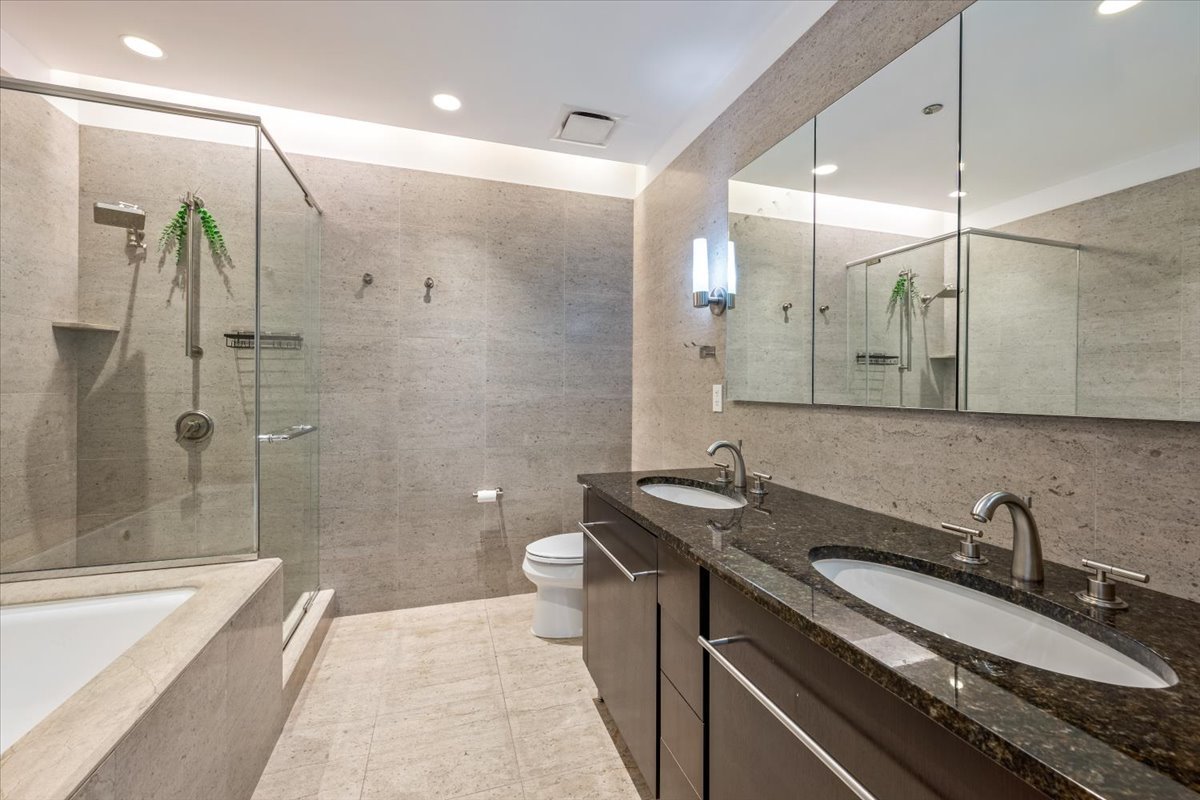 401 North Wabash Avenue, Unit 67F Chicago, IL 60611 - Photo 14 of 44 a bathroom with a granite countertop sink a toilet a mirror and shower