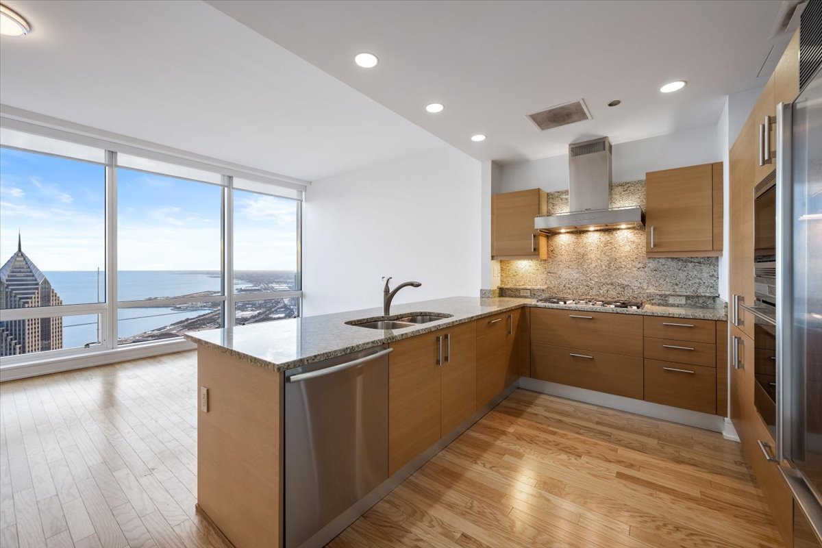 401 North Wabash Avenue, Unit 67F Chicago, IL 60611 - Photo 7 of 44 a kitchen with stainless steel appliances granite countertop a sink and cabinets