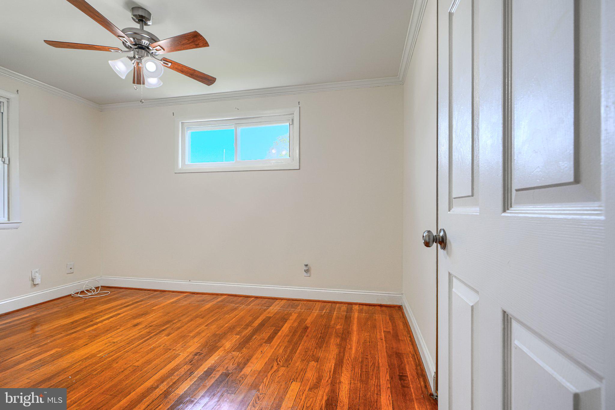 3708 Cassen Road Randallstown, MD 21133 - Photo 13 of 38 a view of a room with wooden floor and a ceiling fan