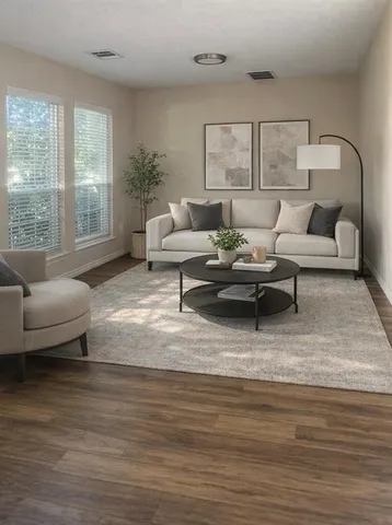 a living room with furniture and a large window