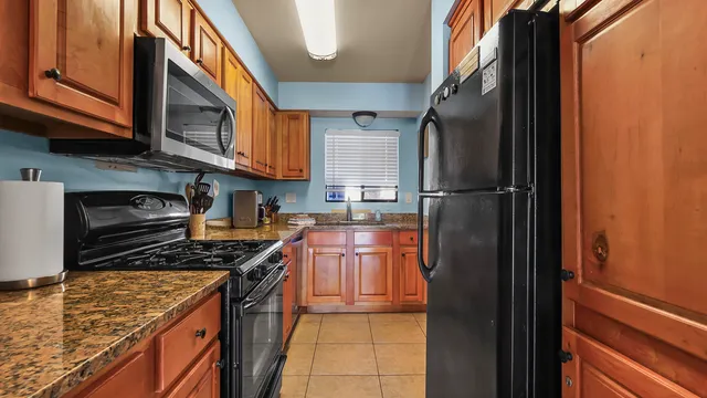 a kitchen with kitchen island sink and window