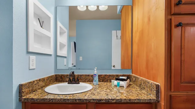 a view of a bedroom with a bed and a balcony