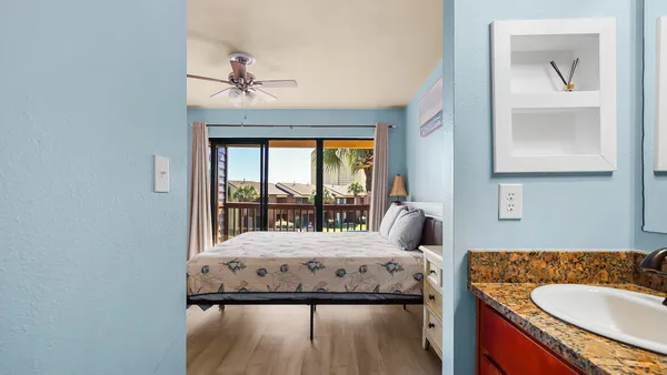 a bedroom with a large bed and a large window