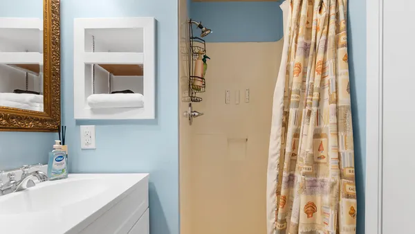 a bedroom with a bed and a lamp on table