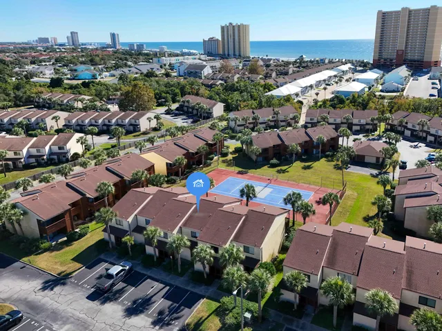 an aerial view of multiple houses with yard