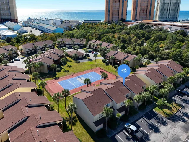 a front view of multiple houses with yard