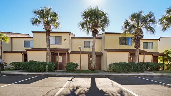 a front view of a house with a yard and a garage