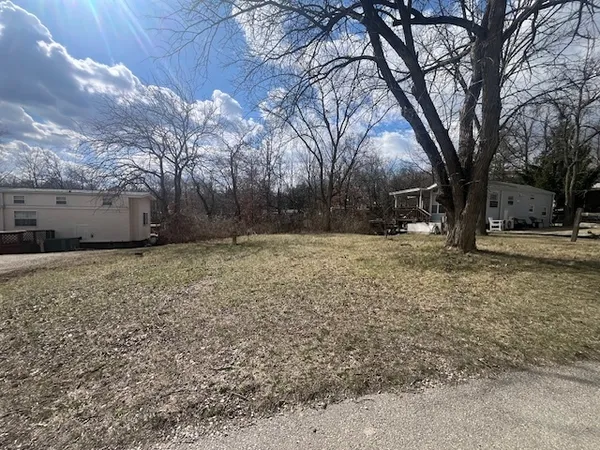 a view of a yard covered with snow in front of house
