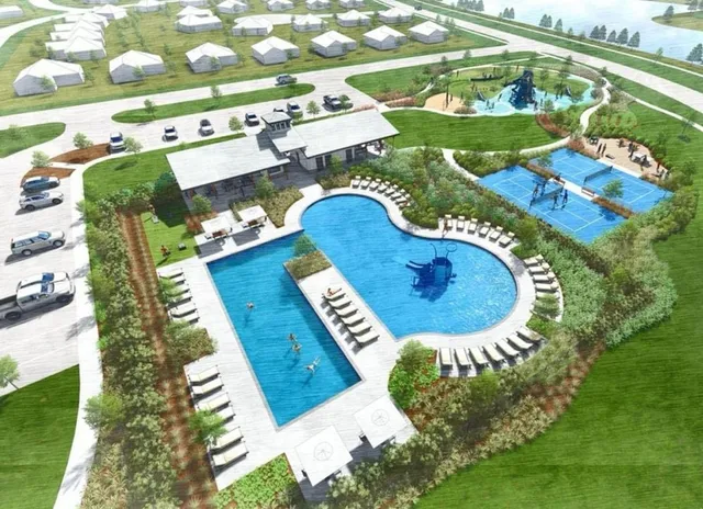 a view of swimming pool is middle in the garden