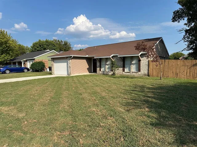 a view of a house with a yard and sitting area