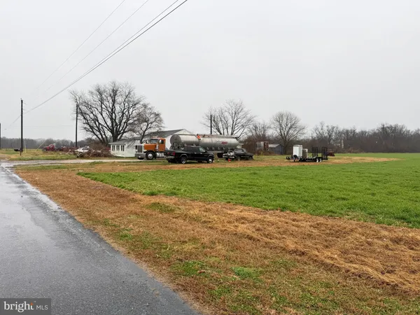 a view of a field with houses in background
