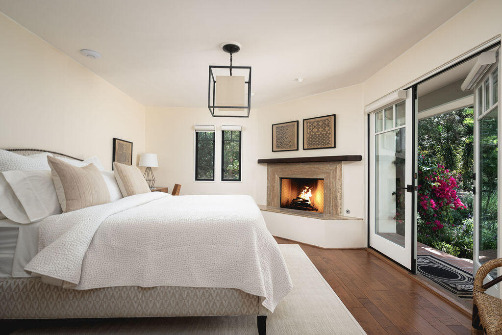 840 Ivy Lane Montecito, CA 93108 - Photo 42 of 57 a spacious bedroom with a bed and a fireplace