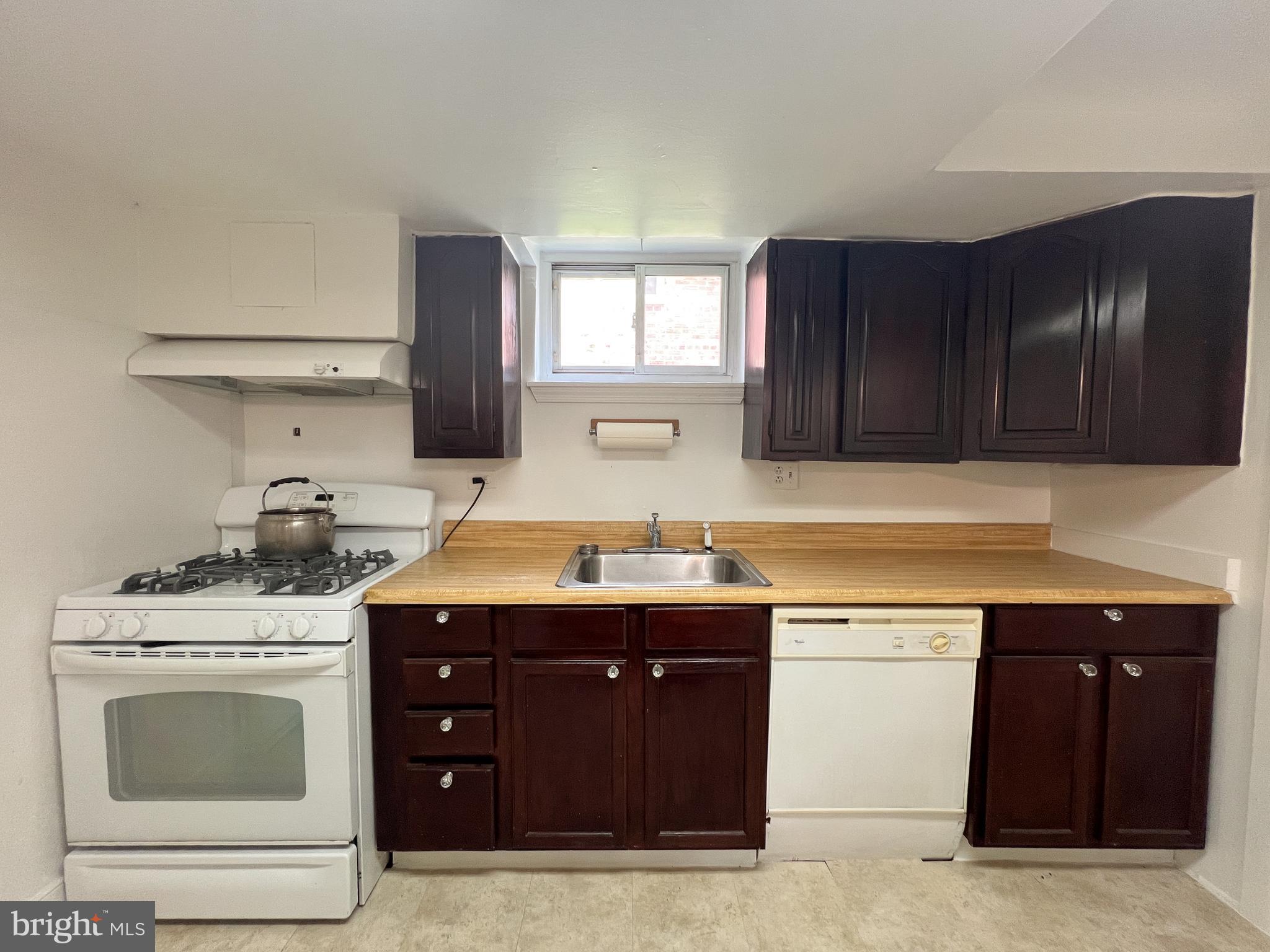 10209 Douglas Avenue Silver Spring, MD 20902 - Photo 8 of 22 a kitchen with a stove sink and cabinets