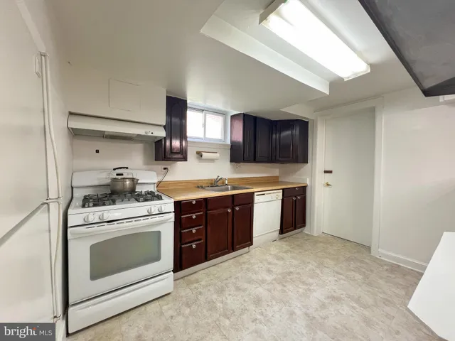 a kitchen with stainless steel appliances granite countertop a stove a sink dishwasher and a refrigerator