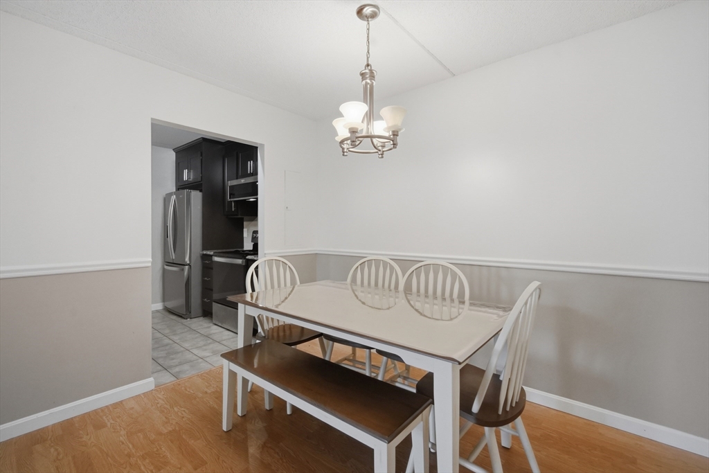 36 Maple Crest Circle, Unit F Holyoke, MA 01040 - Photo 6 of 16 a bedroom with a bed and a chandelier
