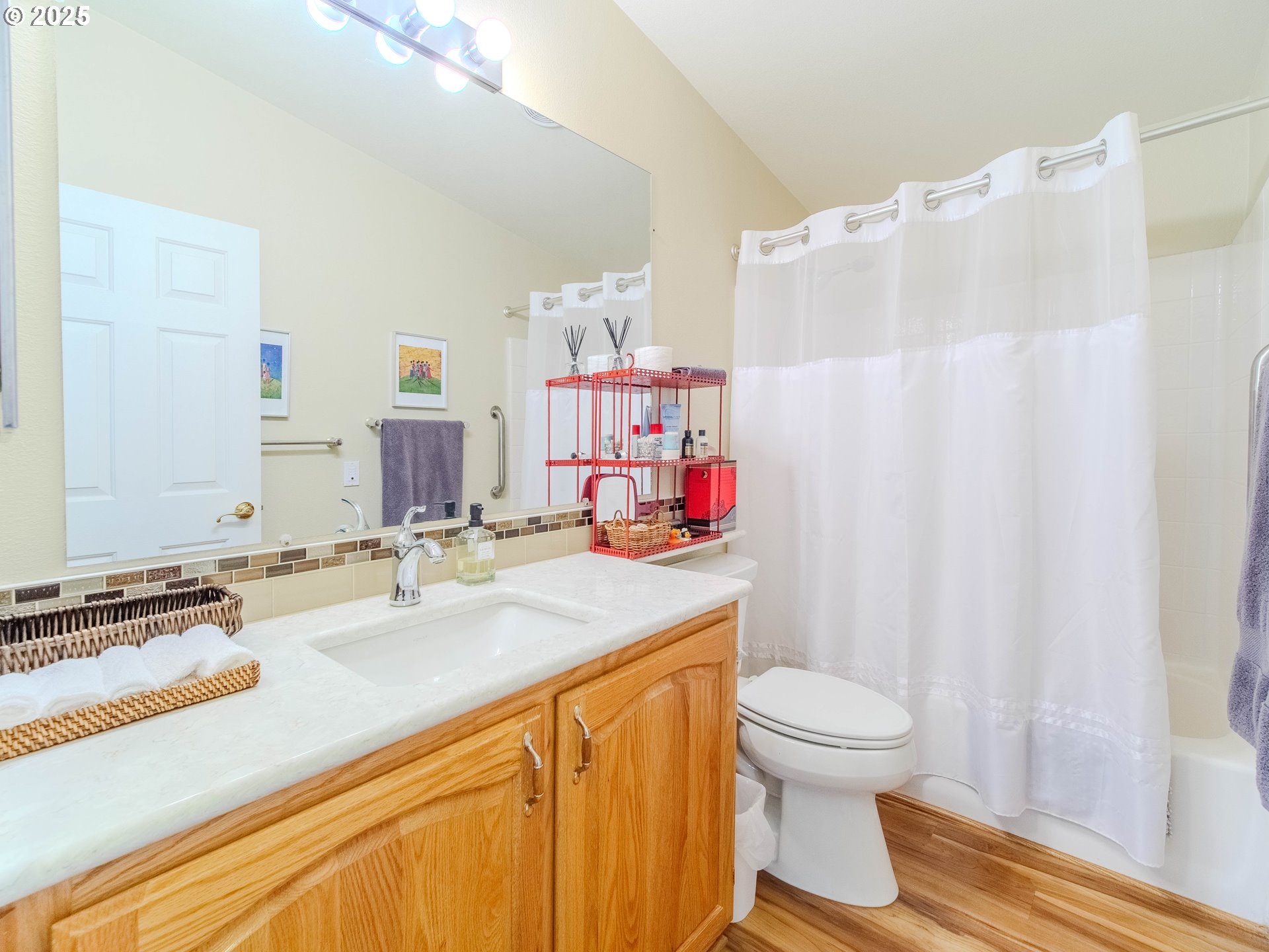 17572 Northwest Shady Fir Loop, Unit 24 Beaverton, OR 97006 - Photo 12 of 31 a bathroom with a sink toilet mirror and vanity