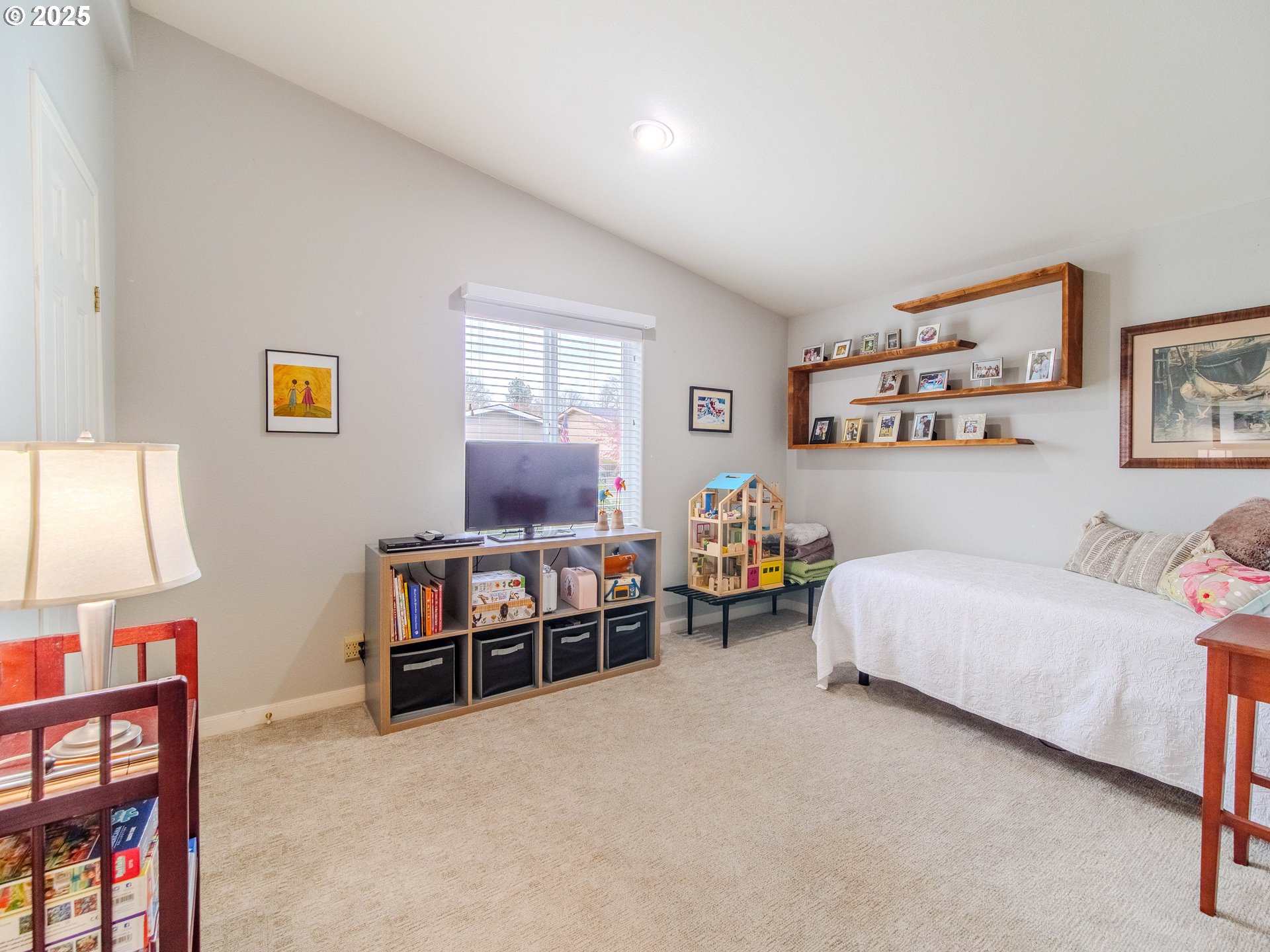 17572 Northwest Shady Fir Loop, Unit 24 Beaverton, OR 97006 - Photo 13 of 31 a bedroom with furniture and a bed
