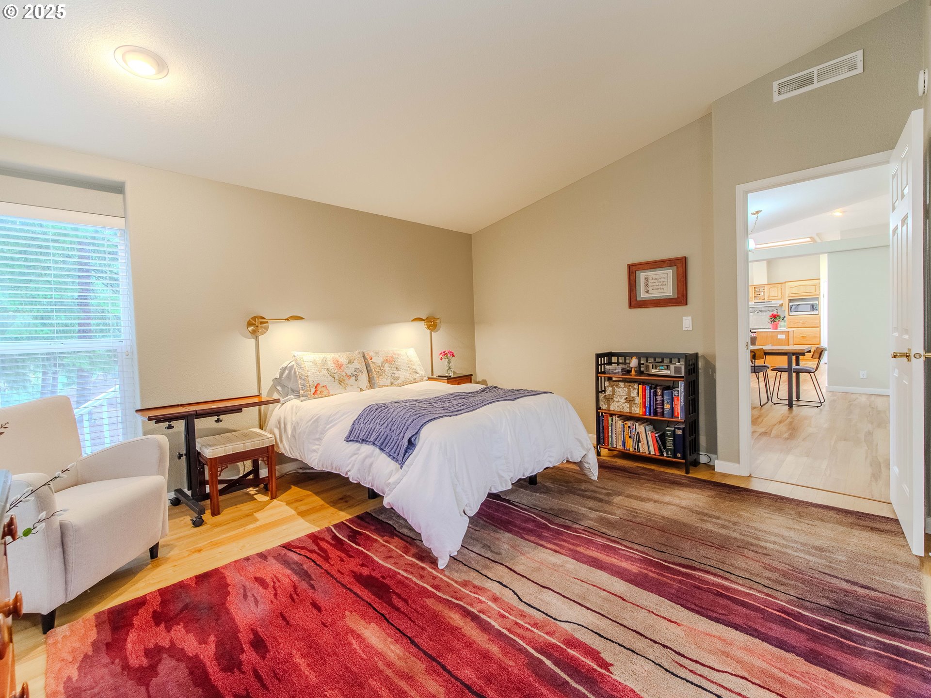 17572 Northwest Shady Fir Loop, Unit 24 Beaverton, OR 97006 - Photo 16 of 31 a bedroom with a bed and wooden floor