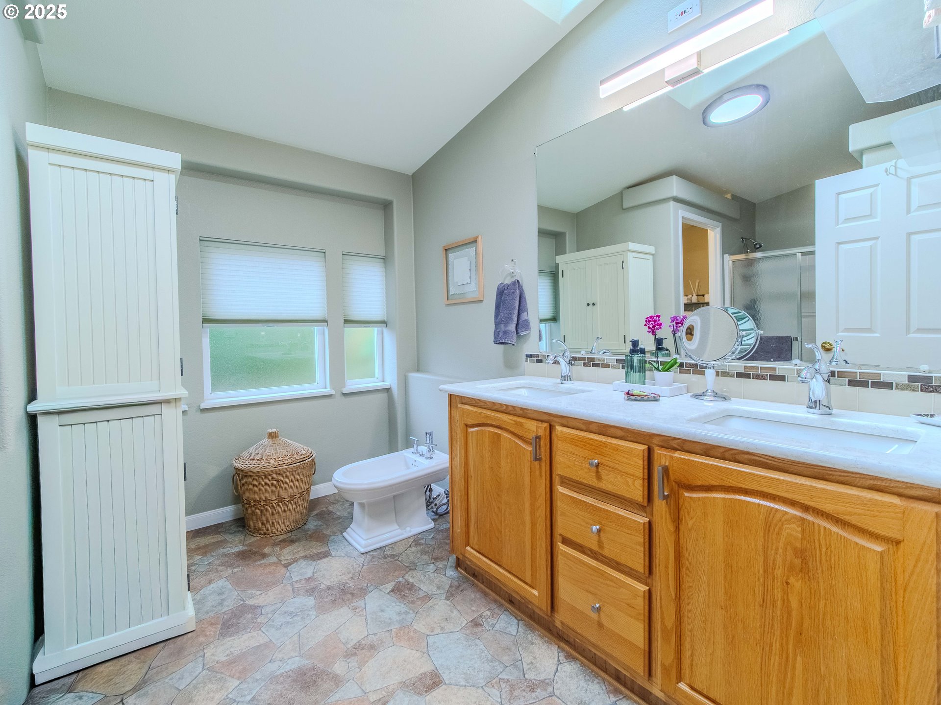 17572 Northwest Shady Fir Loop, Unit 24 Beaverton, OR 97006 - Photo 17 of 31 a spacious bathroom with a sink double vanity and a mirror
