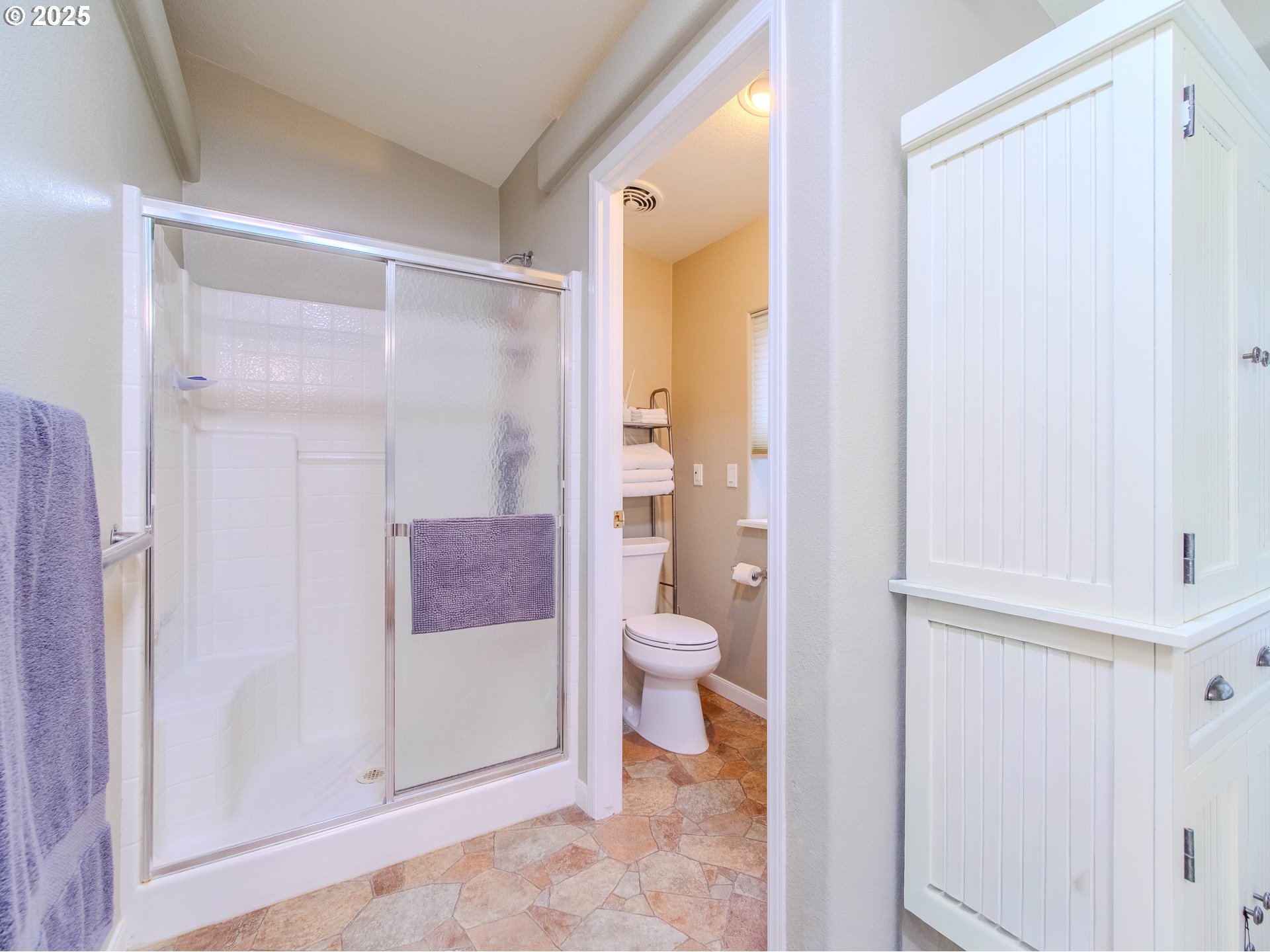 17572 Northwest Shady Fir Loop, Unit 24 Beaverton, OR 97006 - Photo 18 of 31 a bathroom with a granite countertop shower and a toilet