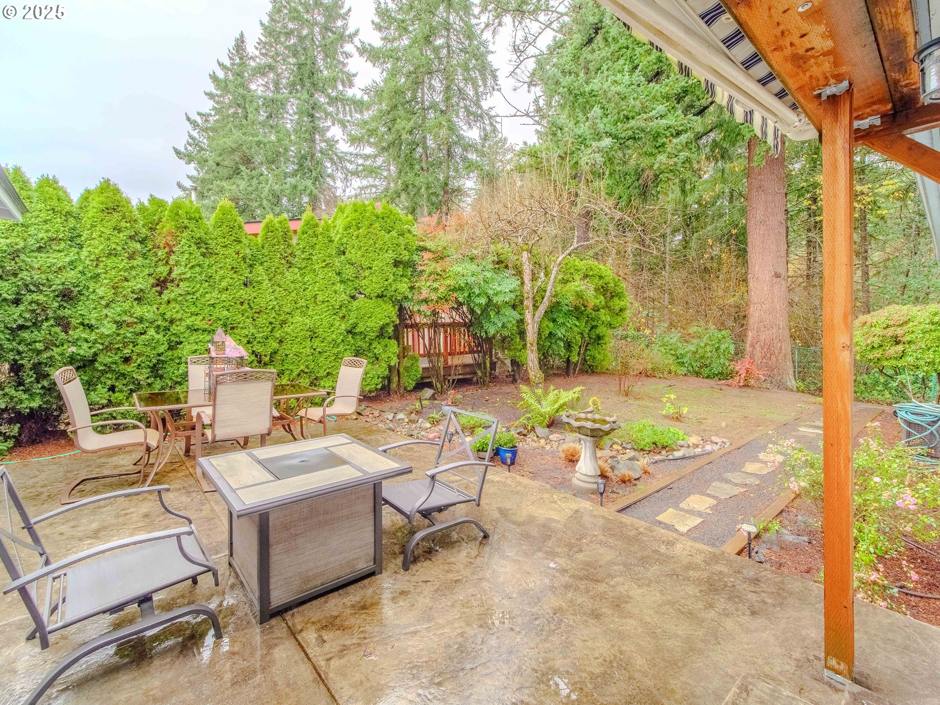 17572 Northwest Shady Fir Loop, Unit 24 Beaverton, OR 97006 - Photo 22 of 31 a view of a patio with a chairs and table in a patio