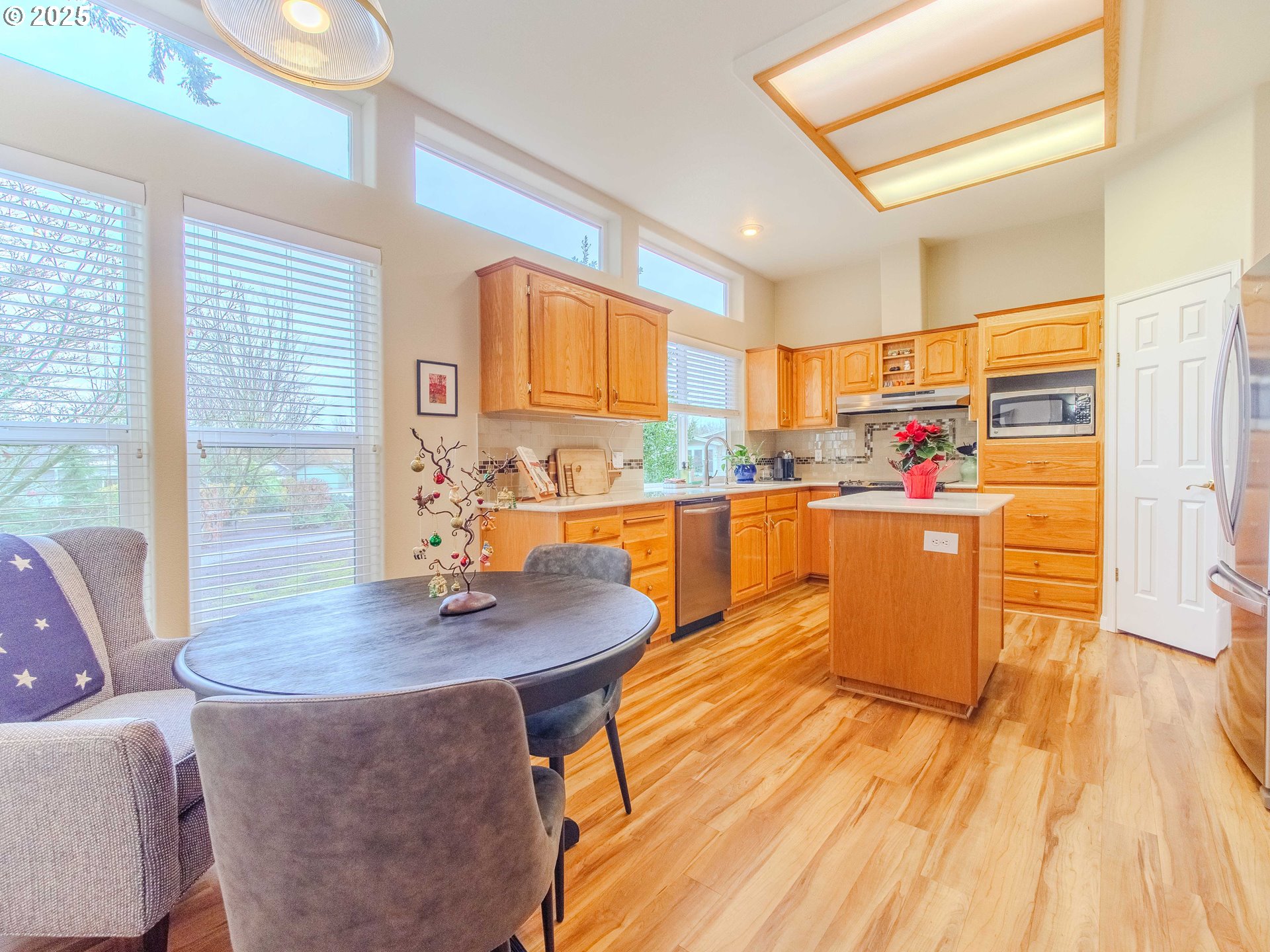 17572 Northwest Shady Fir Loop, Unit 24 Beaverton, OR 97006 - Photo 3 of 31 a kitchen with stainless steel appliances granite countertop a sink and a wooden cabinets