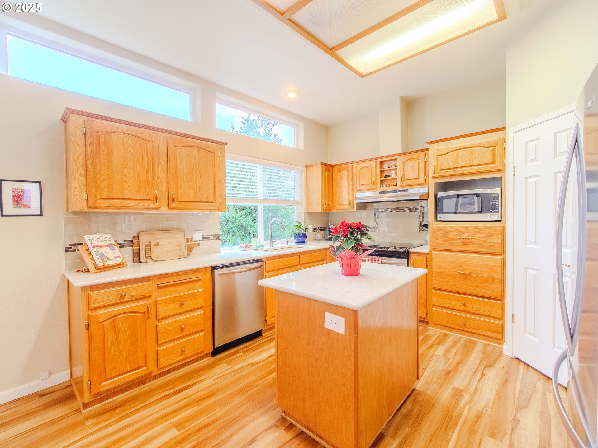 17572 Northwest Shady Fir Loop, Unit 24 Beaverton, OR 97006 - Photo 4 of 31 a kitchen with granite countertop a sink cabinets stainless steel appliances and a window