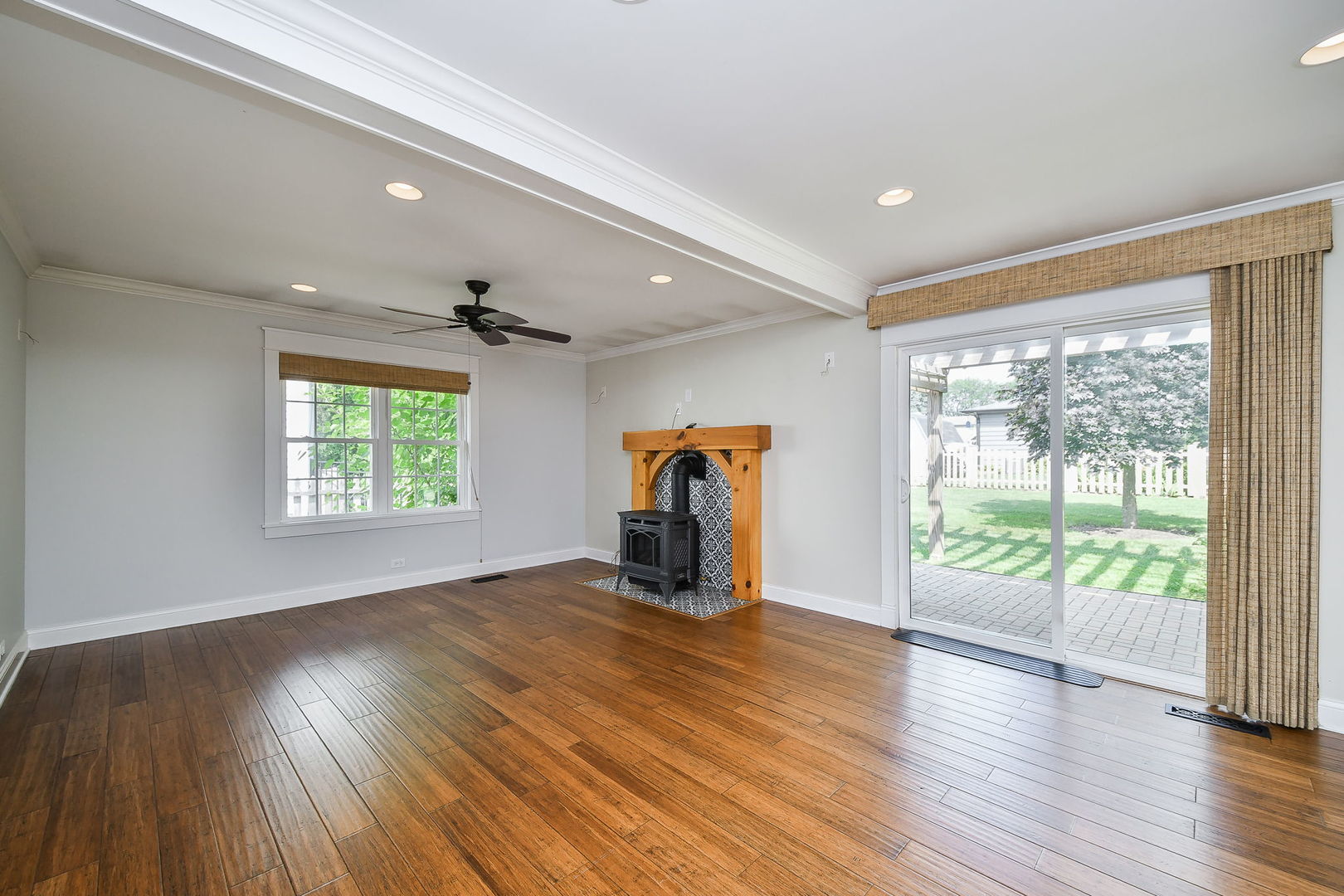 1845 Howard Street Wheaton, IL 60187 - Photo 12 of 29 an empty room with wooden floor fireplace and windows