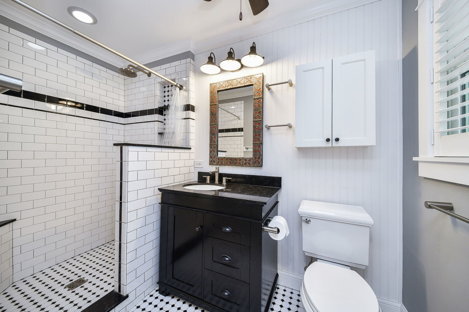 1845 Howard Street Wheaton, IL 60187 - Photo 22 of 29 a bathroom with a granite countertop toilet sink and mirror