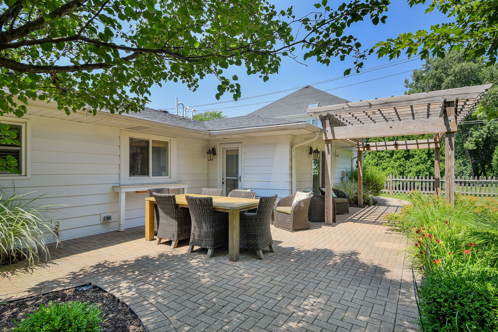 1845 Howard Street Wheaton, IL 60187 - Photo 25 of 29 a view of a patio with table and chairs potted plants and large tree