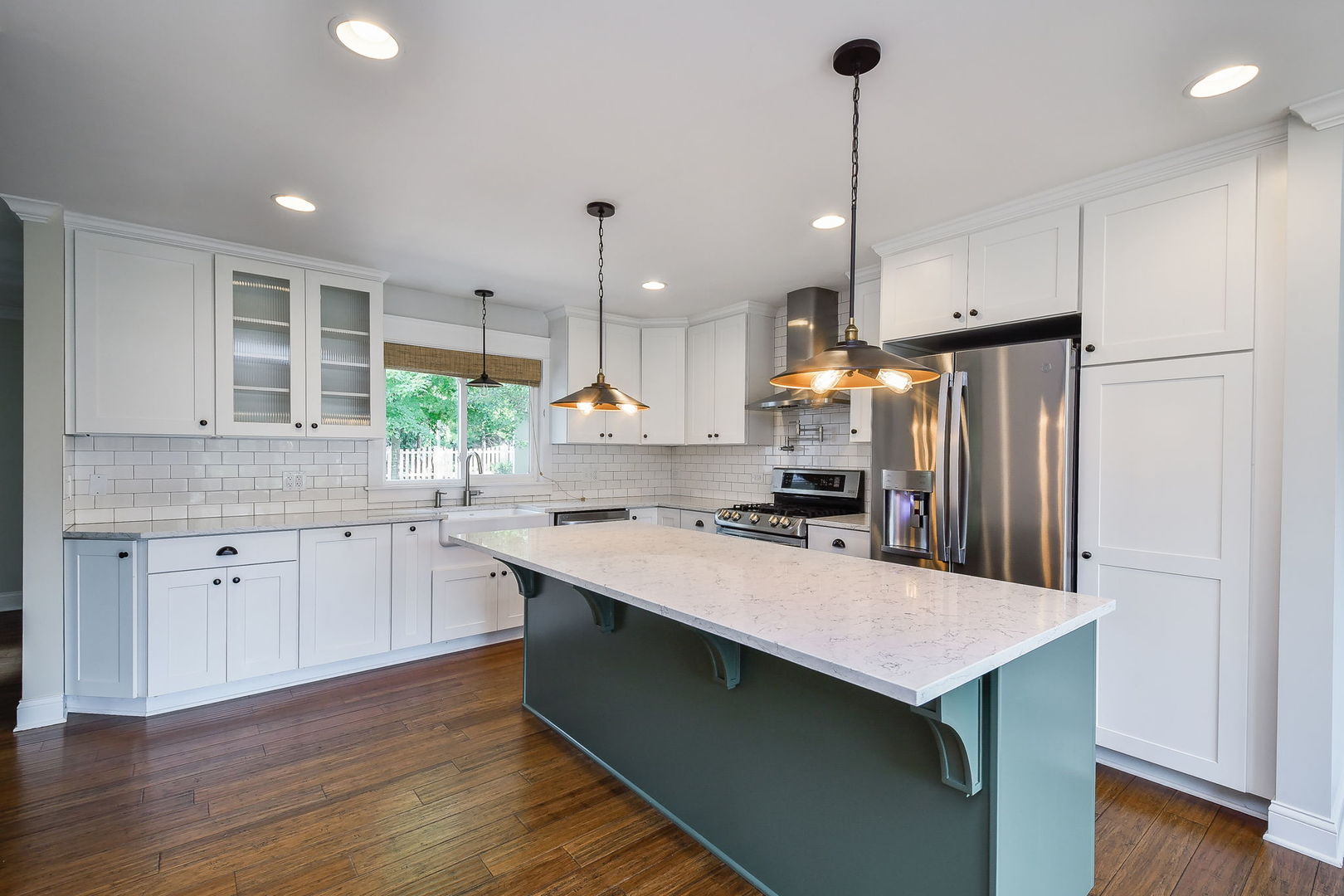 1845 Howard Street Wheaton, IL 60187 - Photo 4 of 29 a kitchen with kitchen island a sink dishwasher a stove a refrigerator and white cabinets with wooden floor
