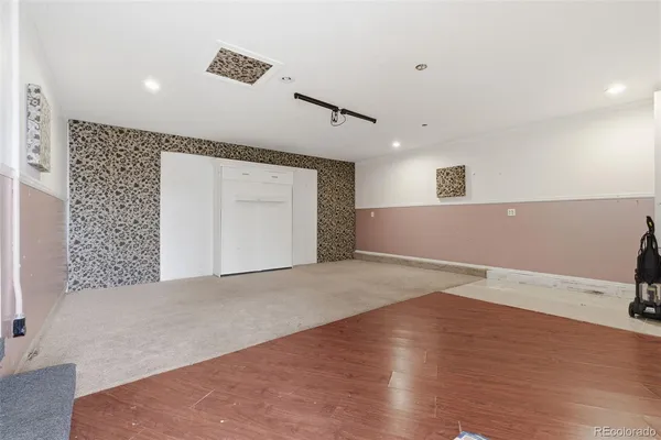 a view of empty room with wooden floor
