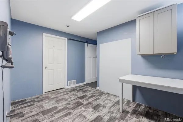 a bedroom with a bed and a cabinet