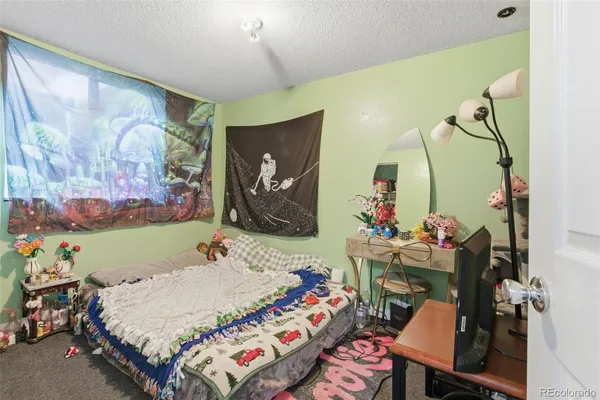 a bed room with a bed mirror and a desk