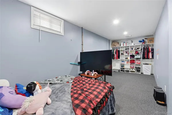 a bedroom with furniture and a flat screen tv