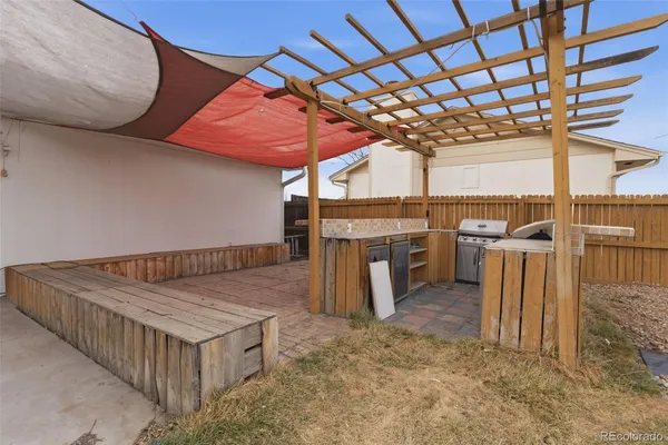 a view of a patio with a table and chairs