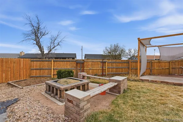 a view of a backyard with sitting area and furniture