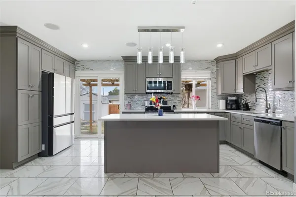 a kitchen with stainless steel appliances a refrigerator sink and cabinets