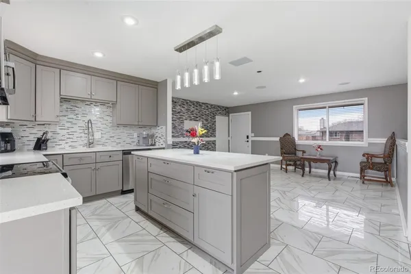 a kitchen with appliances cabinets and chair