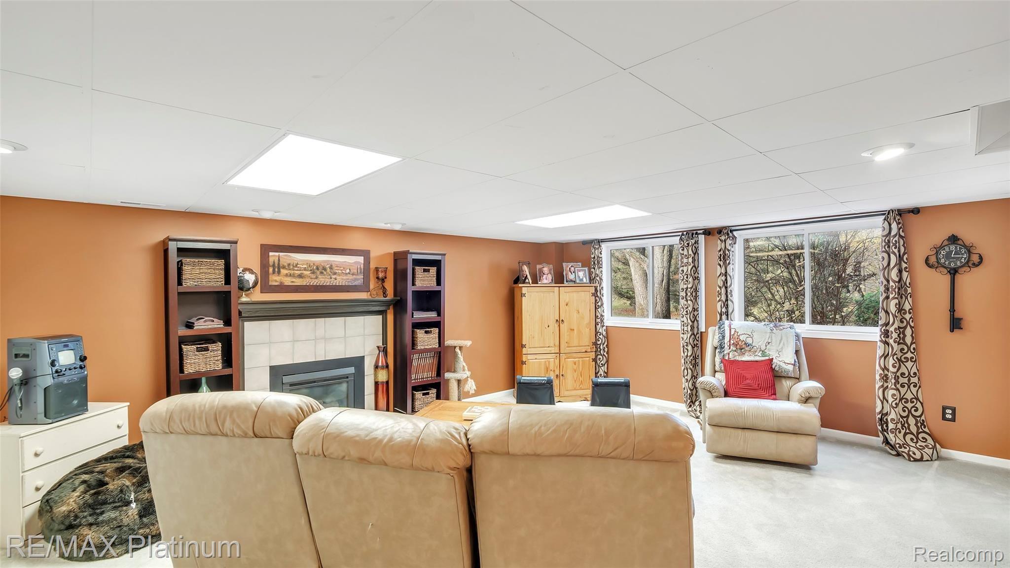 2439 Sunny Ridge Drive Pinckney, MI 48169 - Photo 26 of 42 Extra Living Space In The Finished Basement With Fireplace