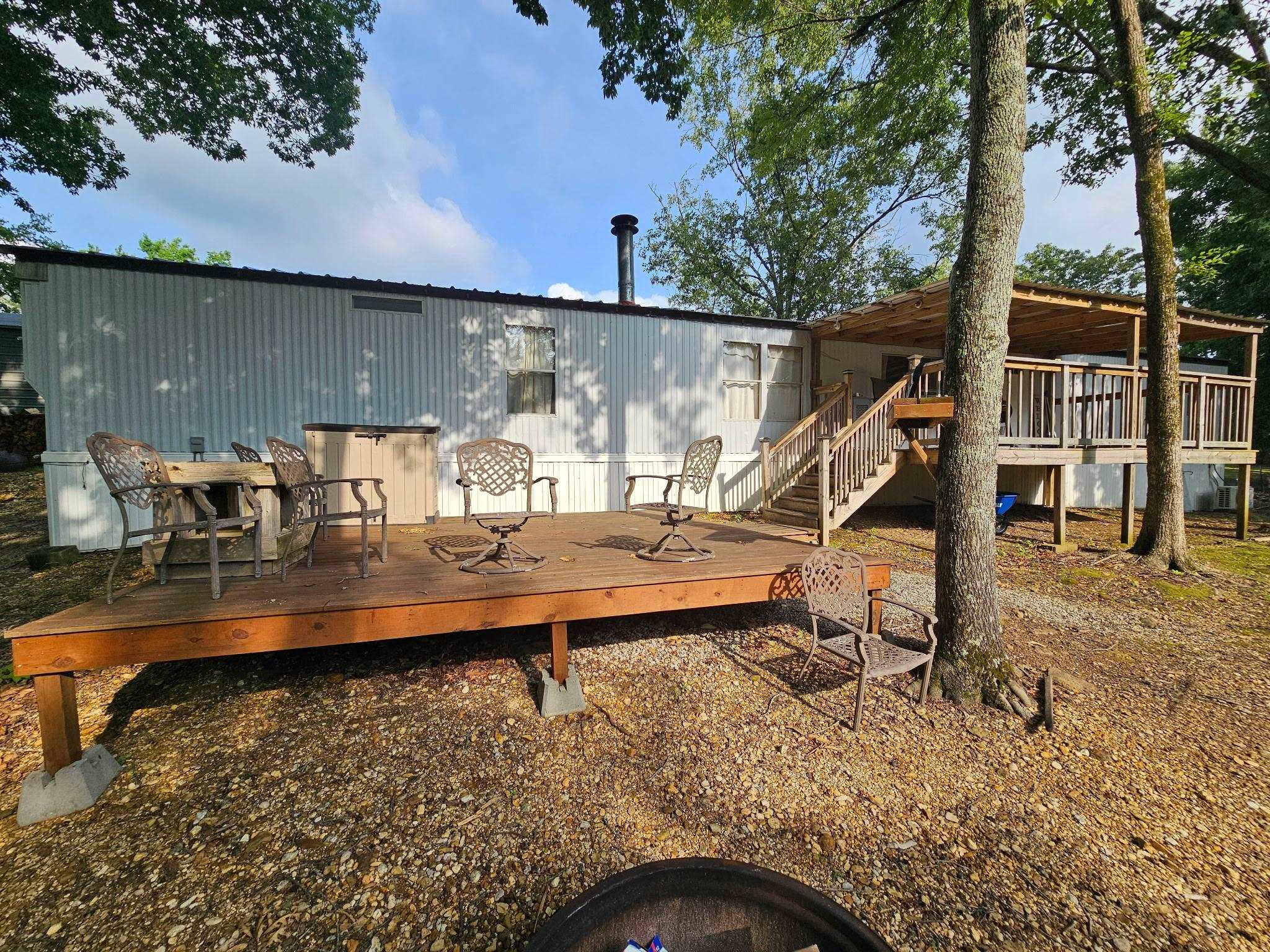 390 Wharf Road Savannah, TN 38372 - Photo 16 of 17 Exterior featuring a wood deck, elevated covered porch, and a white siding facade