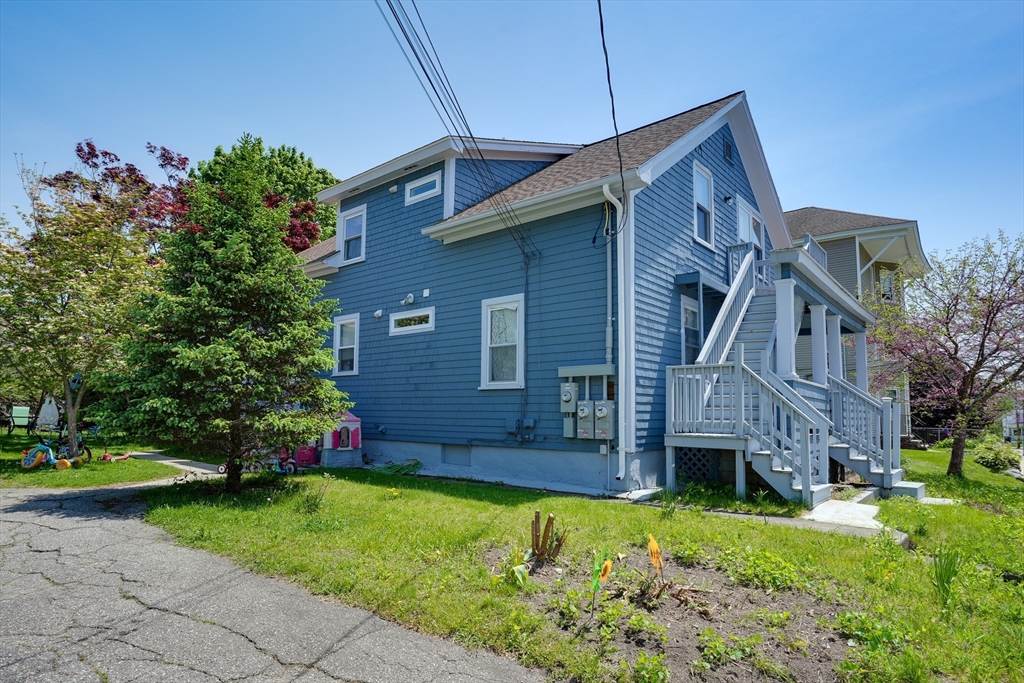 5 Eddy Street, Unit 2 Webster, MA 01570 - Photo 2 of 18 a front view of a house with garden