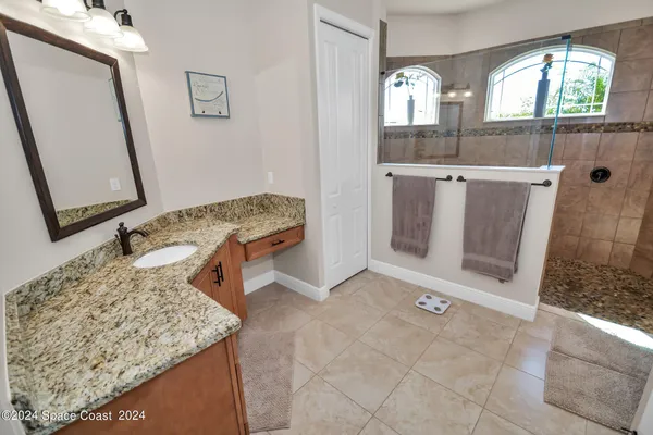 a view of a bathroom with mirror and window