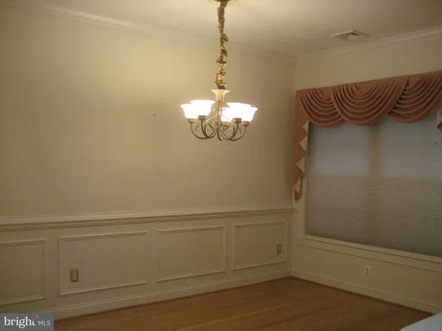 a view of a chandelier fan and wooden floor