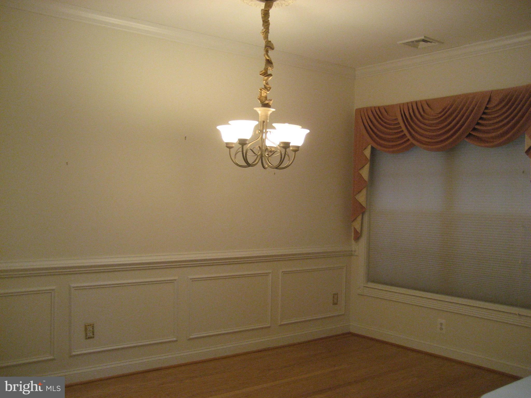 180 Carriage Chase Circle Warrenton, VA 20186 - Photo 6 of 22 a view of a chandelier fan and wooden floor