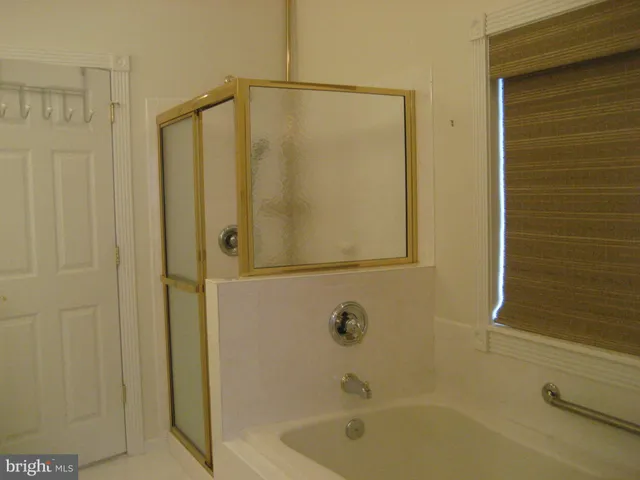 a bathroom with a shower and a tub